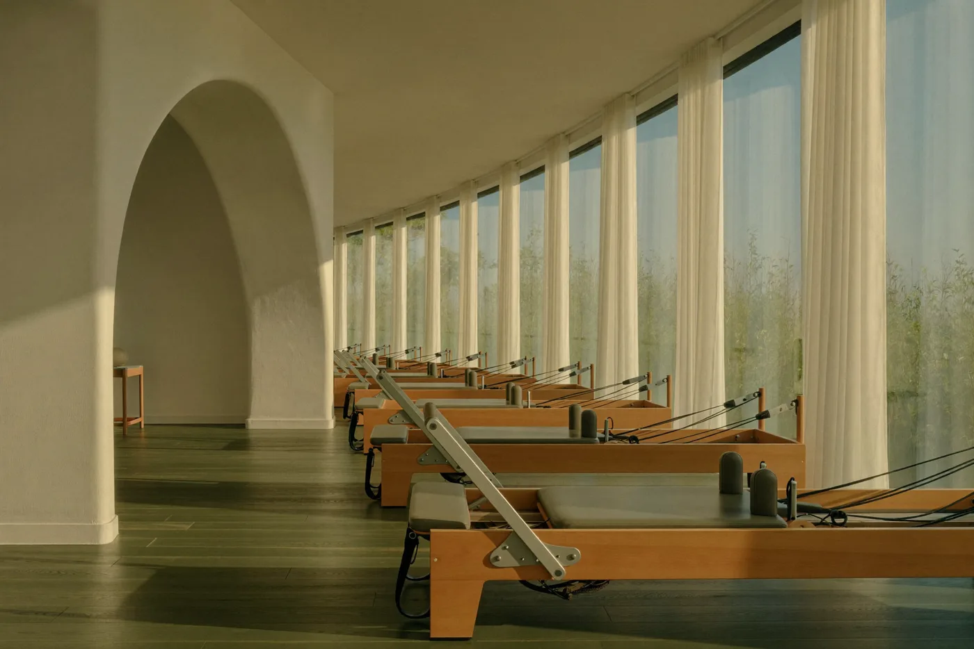 Boutique pilates studio with reformers in golden morning light